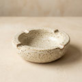AI concept of an ivory speckled round ashtray
