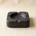 AI concept of a charcoal square ashtray with rounded corners
