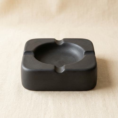 AI concept of a charcoal square ashtray with rounded corners